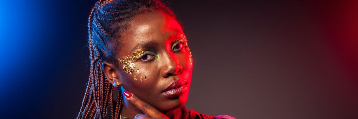 young-african-woman-with-afro-hairstyle-and-golden-shiny-makeup-studio-shot-.jpg