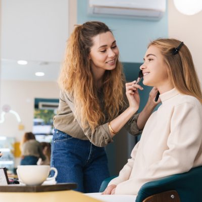 beauitufl-smiling-young-woman-getting-her-makeup-done.jpg